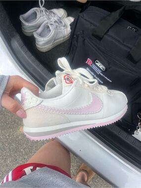 Nike White Sneakers with Pink Accents and Heart Logo